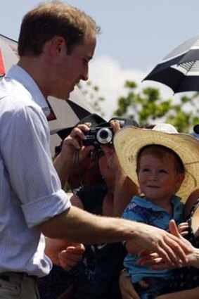 Prince William greets people after his arrival in Cardwell, Queensland this afternoon.