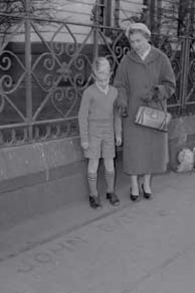Robert Waddell, aged nine, with his mother Beryl at the corner of Flinders and Williams streets in 1960.