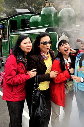Passive smokers: tourists take in the atmosphere of Puffing Billy.