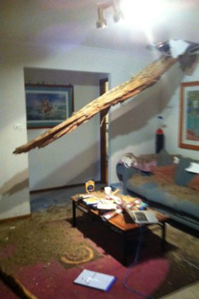 Jane Klose was sitting on this couch watching television when a gum tree was hit by lightning and exploded, sending this shard through her roof above her head. <i> Photo: Jane Klose </i>