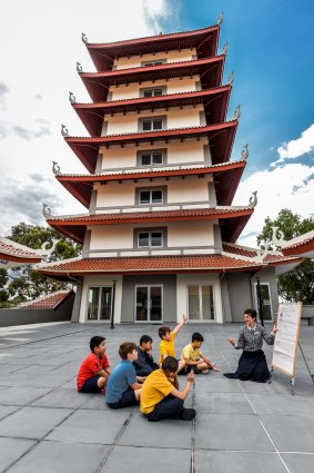 Students at Hoa Nghiem Primary in Springvale take part in a class outside the temple. 