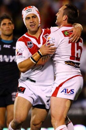 Back on track ... Jamie Soward, left, of the Dragons celebrates scoring against the Panthers yesterday.