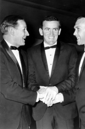 Dick Reynolds, left, and Bob Skilton, right, in 1966 congratulating Ian Stewart on joining the triple-Brownlow medalist club.