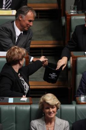 A bucket labelled 'no carbon tax' is moved from the opposition benches by direction of the Speaker.