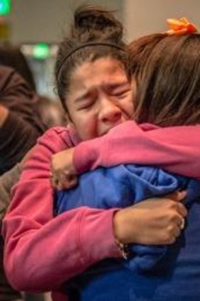 A community in prayer: 13-year-old Kimberly Macias cries as she sees schoolmates at a vigil for the victims on Tuesday in Roswell, New Mexico. 