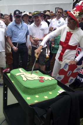 It's a carve-up: Barmy Army figurehead Vic Flowers sticks the knife in as England fans celebrate their 20th birthday.