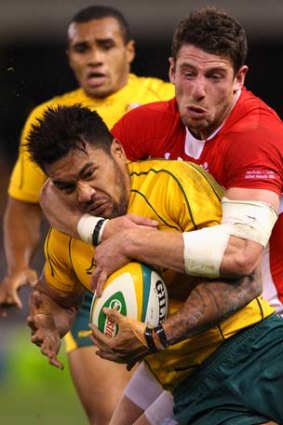 Digby Ioane attempts to break the tackle.