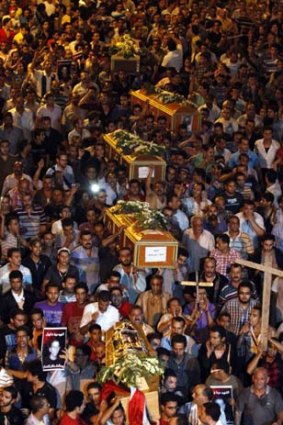 A mass funeral makes its way to the Abbasiya Cathedral.