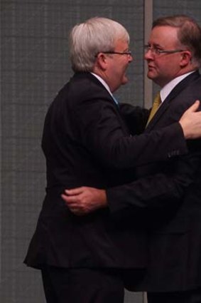 Anthony Albanese hugs Labor MP Kevin Rudd after he announced his resignation.