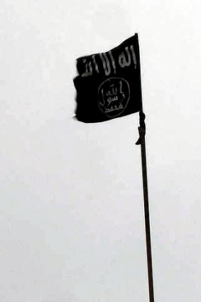 A black flag, trademark of jihadists, is hoisted over Sheikh Suleiman base.