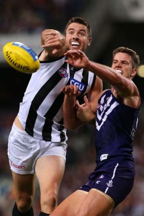 David and Goliath: Fremantle youngster Jack Hannath (right) tangles with Collingwood veteran Darren Jolly.