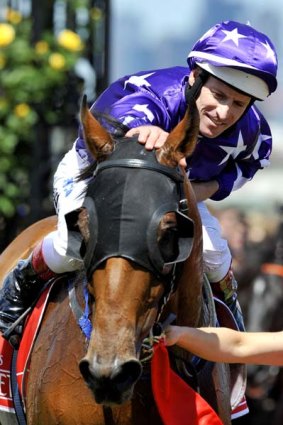 The winner of the Emirates Stakes, Wall  Street, is congratulated by jockey Hugh Bowman.