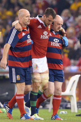 Fallen leader: British and Irish Lions captain Sam Warburton is helped off the field injured against the  Wallabies in Melbourne.