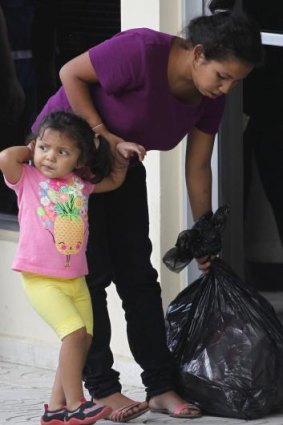 A woman holds her daughter's hand after being deported from the US at the international airport in San Pedro Sula, northern Honduras, last week.