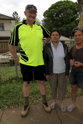 Chin Tran and his wife Nam with Dave Beard who has volunteered to help the couple rebuild their home.