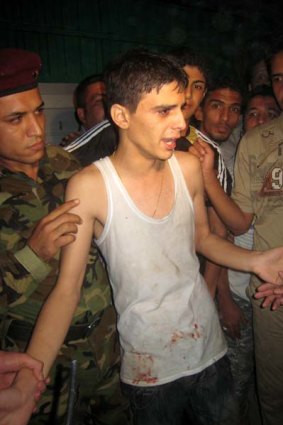 Iraqi security forces and wellwishers surround an Iraqi youth after his release from  a Baghdad church.