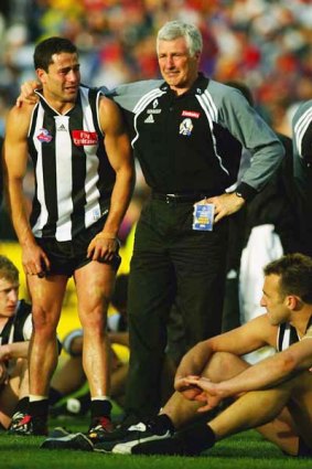 Mick Malthouse tries to console Paul Licuria after the Magpies were beaten by Brisbane in the 2002 grand final.