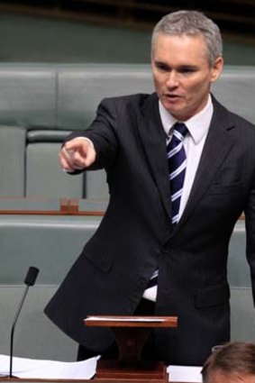 Craig Thomson points at Opposition Leader Tony Abbott as he concludes his statement to the House of Representatives at Parliament House Canberra on Monday.