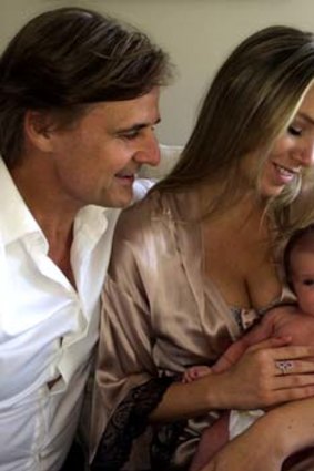 And baby makes three: Siimon Reynolds, Kathryn Eisman and baby Capri.