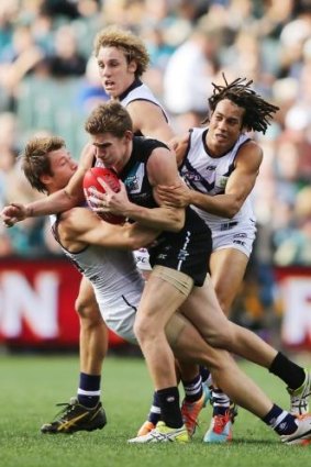 Power play: Fremantle throws its defences at Port Adelaide’s Matt White.