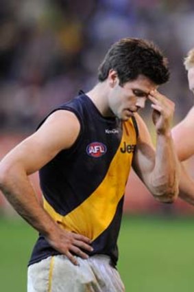 Tigers burning out: Trent Cotchin, left, Steve Morris and Luke McGuane in disbelief at losing to Carlton.