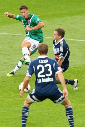 Nathan Burns of the Jets scores one of his goals against Melbourne Victory.