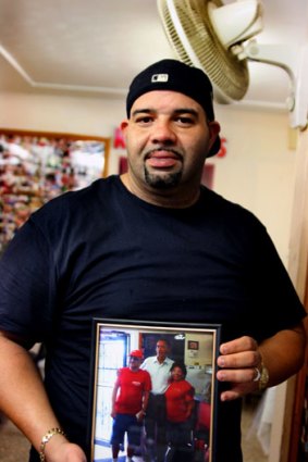Andy Russell from the West Tampa Sandwich Shop with a photo of Barack Obama when he visited.