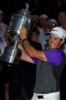 Lone star: Rory McIlroy lifts the Wanamaker trophy after winning the PGA Championship.
