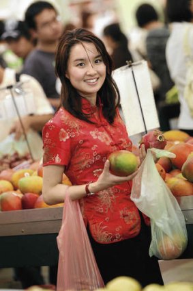"The marketplace is a law unto itself" … author Alice Pung shops for mangoes.