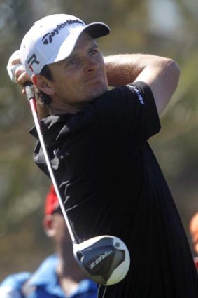 Justin Rose of England watches his shot from the ninth tee during the second round of the Abu Dhabi Golf Championship.