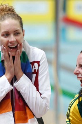 Alicia Coutts (C) and Emily Seebohm, share a joke with Hannah Miley from Scotland.
