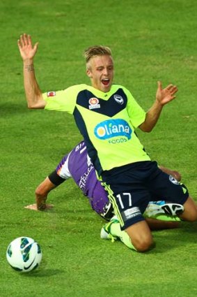 Victory's James Jeggo is brought down by Jacob Burns of Perth Glory during the round 17 A-League match at nib Stadium on Saturday.