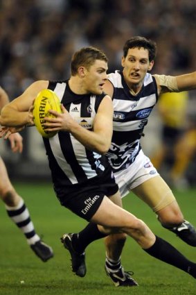 Geelong's Harry Taylor in pursuit of Collingwood's Heath Shaw during their round 19 cclash.