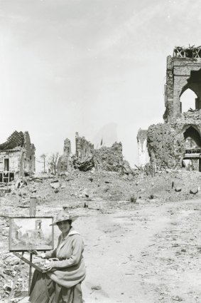 A portrait of  Evelyn Chapman, the first Australian female artist to visit the battlefields, while at work in Villers-Bretonneux 1919.This photograph shows all that is left of the church of Villers-Bretonneux.