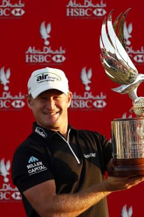 Jamie Donaldson of Wales holds the trophy after winning the Abu Dhabi Golf Championship.
