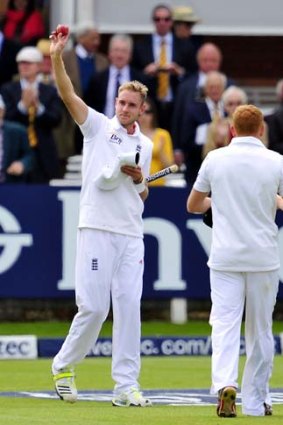 Stuart Broad holds the ball and a stump as souvenirs after taking seven wickets to bowl England to victory.