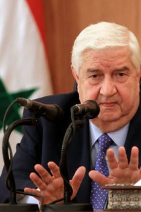 Syrian Foreign Minister Walid Muallem speaks during a press conference rejecting an Arab League solution to the unrest sweeping his country.