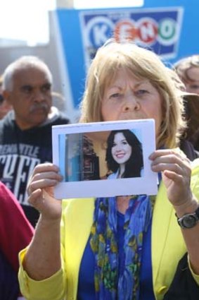 A marcher holds an image of Jill Meagher.