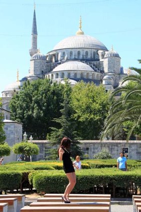 Spectacularly inappropriate ... a girl dances at Istanbul's Blue Mosque.