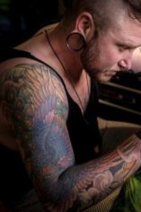 Tattoo artist Zero Scar at work in his studio in West Footscray. 
