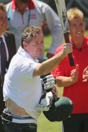 Piers Morgan salutes the crowd after facing deliveries from Brett Lee in the nets.