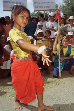 A young Cambodian girl performs the jeeb hand position during a traditional dance.