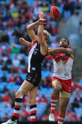 Adam Goodes spoils a mark for Nick Riewoldt.