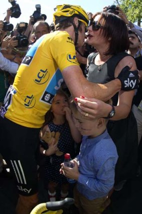 Bradley Wiggins kisses his wife Catherine after being crowned winner of the Tour de France.
