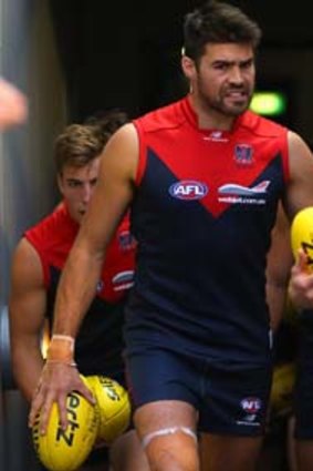 Not an inkling of what lay ahead: Nathan Jones (right) leads the Demons out for the game against the Gold Coast.