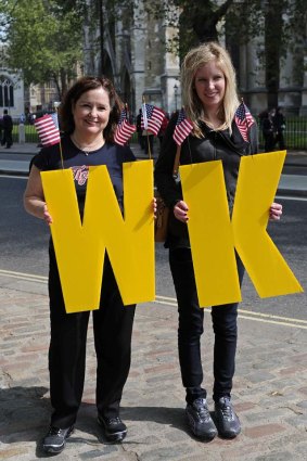 Royal fans Olivia Wofford (R) and her mother Christine, from Michigan, USA, with the initials W and K  outside  Westminster Abbey.