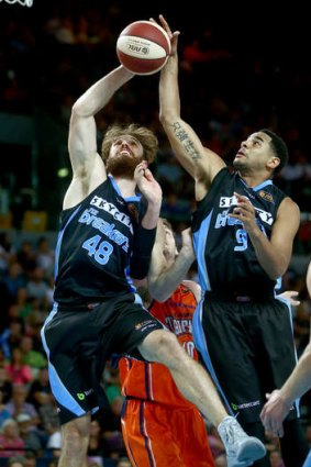 Casey Frank and Corey Webster look for the loose ball  during the round 18 NBL match between the New Zealand Breakers and the Cairns Taipans at Vector Arena.
