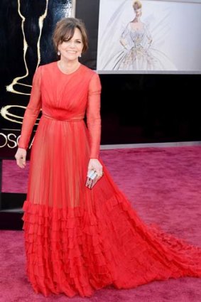 Lady in red: Sally Field whooshes into the Oscars.