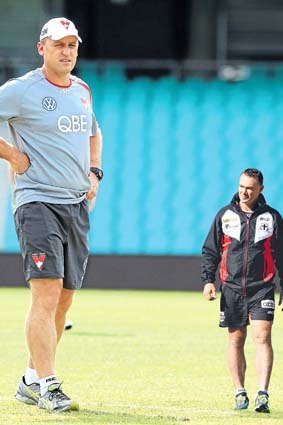 Different perspectives: While John Longmire's Sydney Swans are flying, for Alan Richardson's battling Saints, the only way is up.