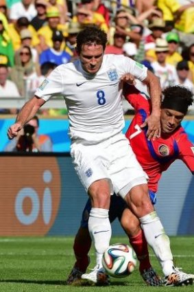 England's Frank Lampard (L) in action against Costa Rica's Cristian Bolanos at the World Cup.